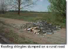 Roofing shingles dumped on a rural road